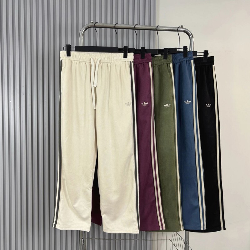 Adidas three-stripe sweatpants in a suede-touch, lightly water-repellent fabric