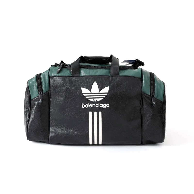 Balenciaga × Adidas co-branded duffle in black with deep green panels — an oversized weekender format