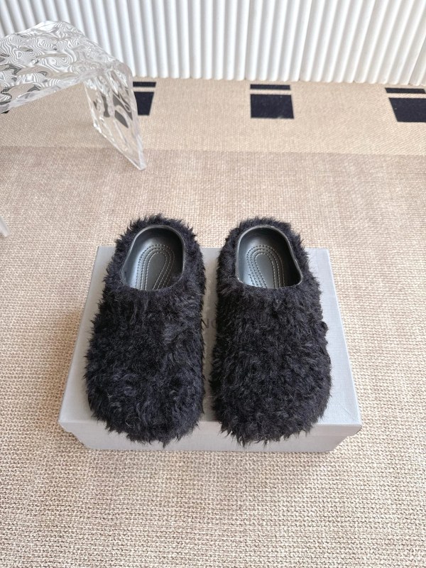 Balenciaga black faux-shearling platform slides sold in paired EU size brackets