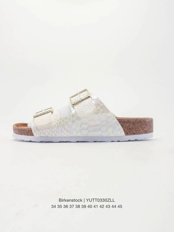 Birkenstock white slide on a cork-latex footbed with a soft leather upper