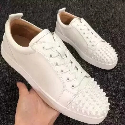 Christian Louboutin white sneakers in classic athletic style, listed in calfskin with studded colorblock uppers
