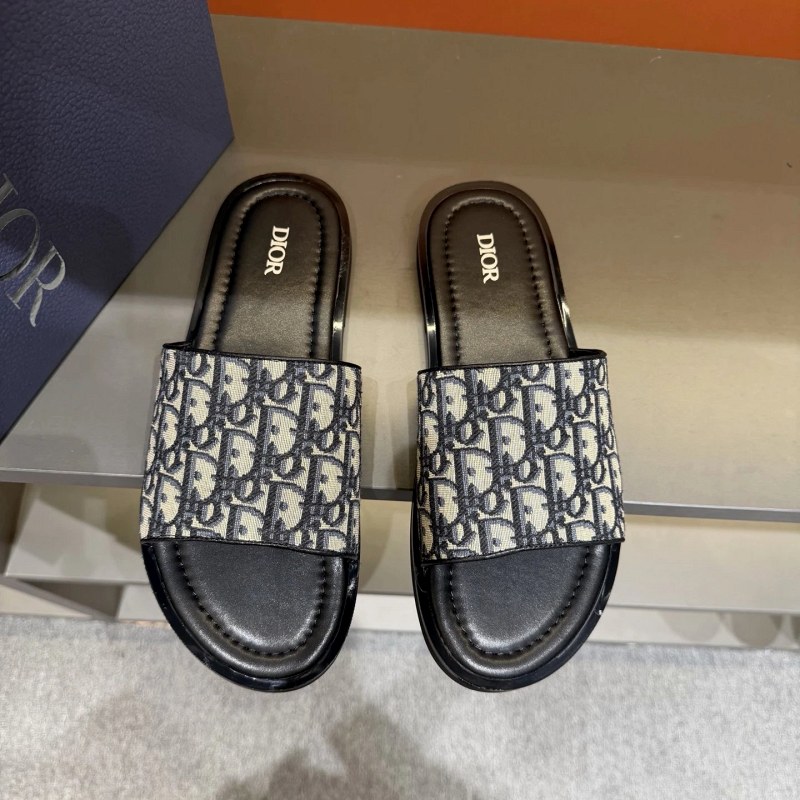 Dior black crossover slides in grained calfskin with a Diamond brass logo and Oblique-print outsole