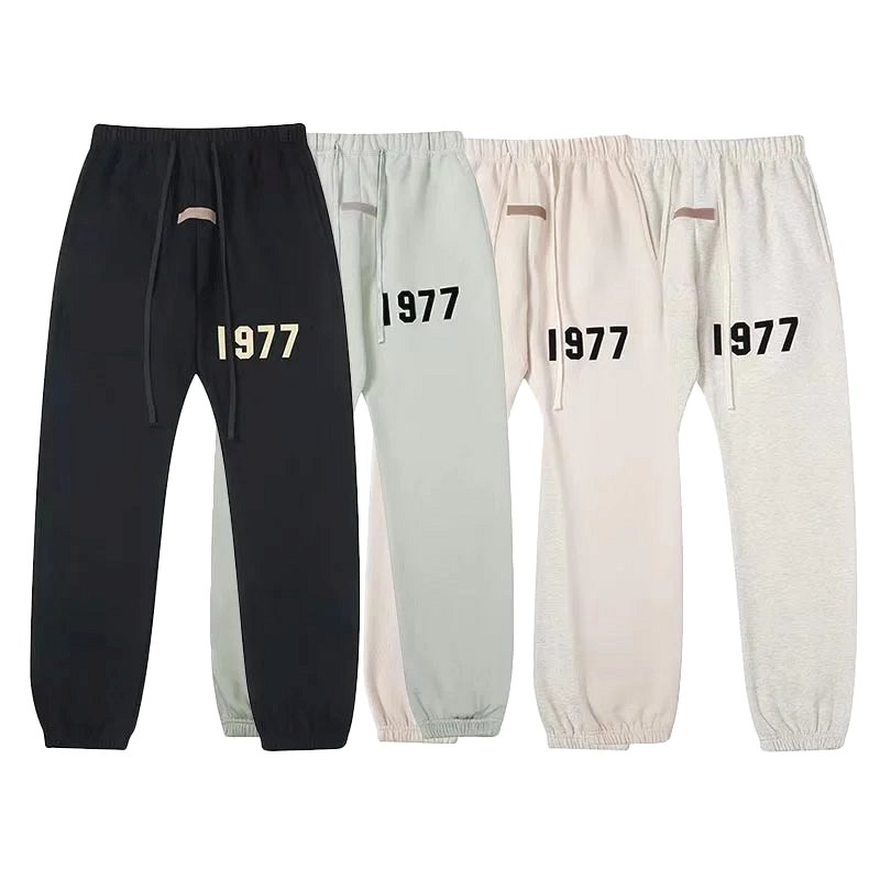Fear of God Essentials black sweatpants: fleece-lined cotton in a cuffed straight leg