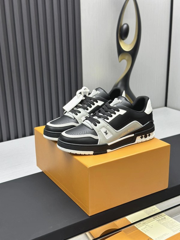 Louis Vuitton black low-top sneakers in the classic LV Trainer layered-panel style, with a documented size-down fit