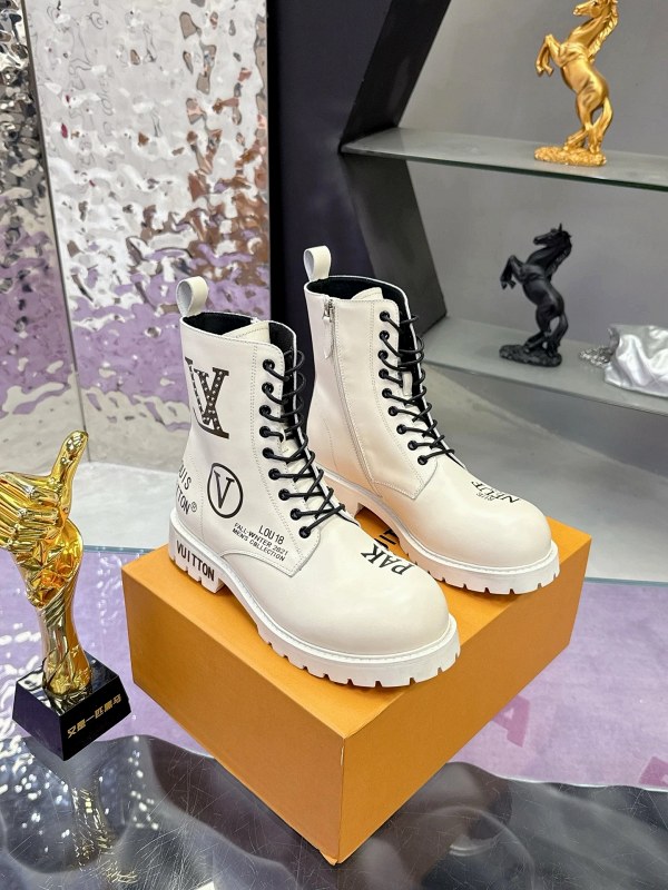 Louis Vuitton white sneakers with graffiti studs, side zips, and a thick platform sole