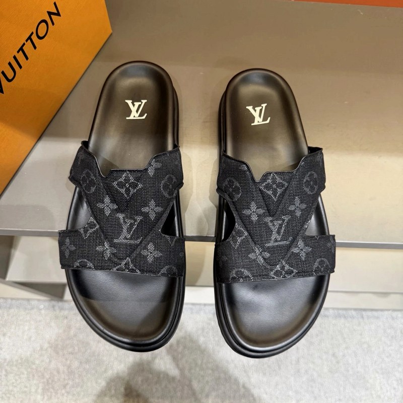 Louis Vuitton black slides with a stated Italian-imported upper and cowhide insole
