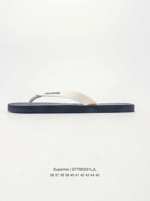 Supreme gray open-toe rubber slides with a Kaws-themed graphic design