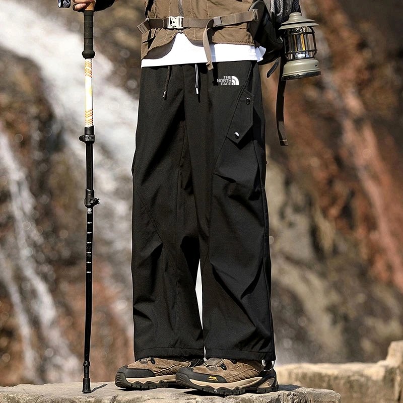 The North Face gray utility-style outdoor pants with embroidered detailing