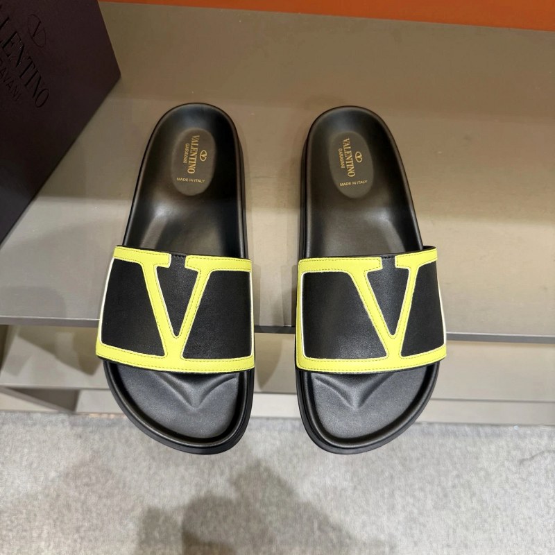 Valentino black slides with a metal logo and calf leather upper