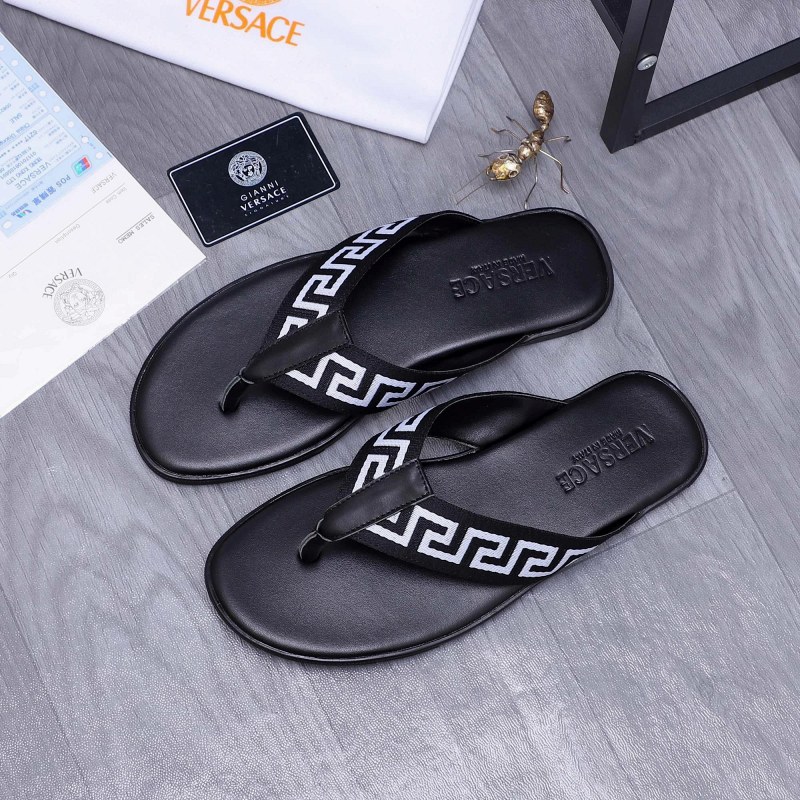 Versace black slides with a webbing-and-leather upper and rubber outsole