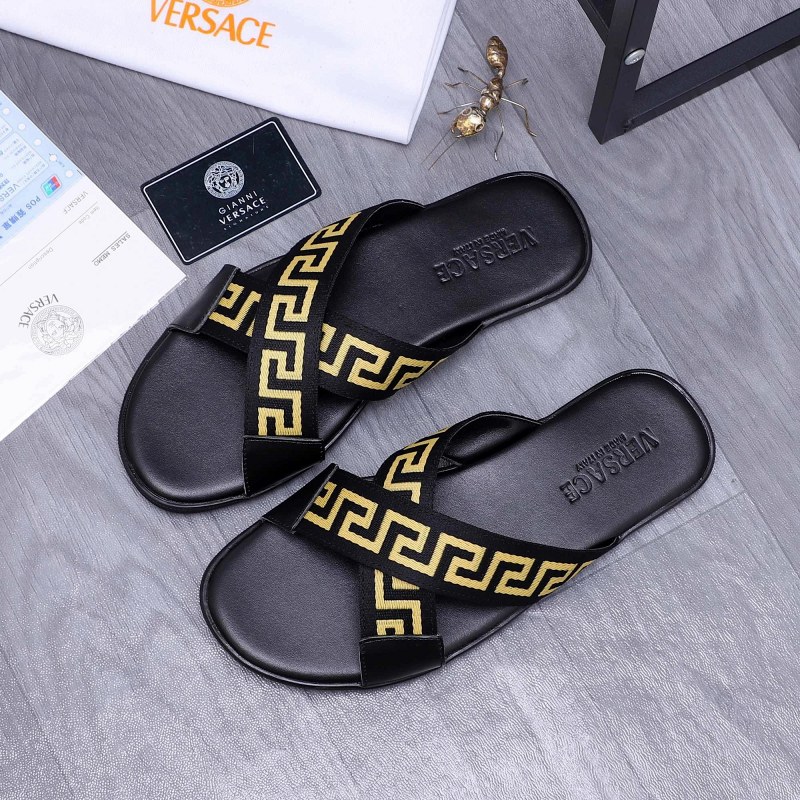 Versace black slides with a woven webbing and leather upper on a rubber outsole